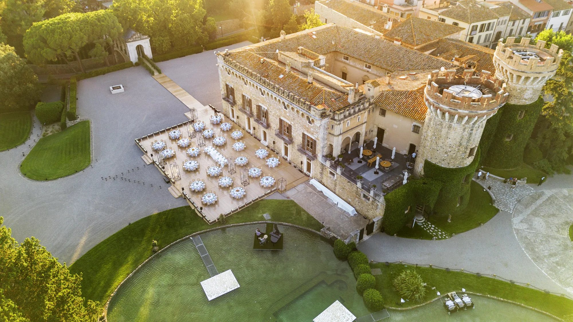 Aerial view of a castle and its garden reception at sunset
