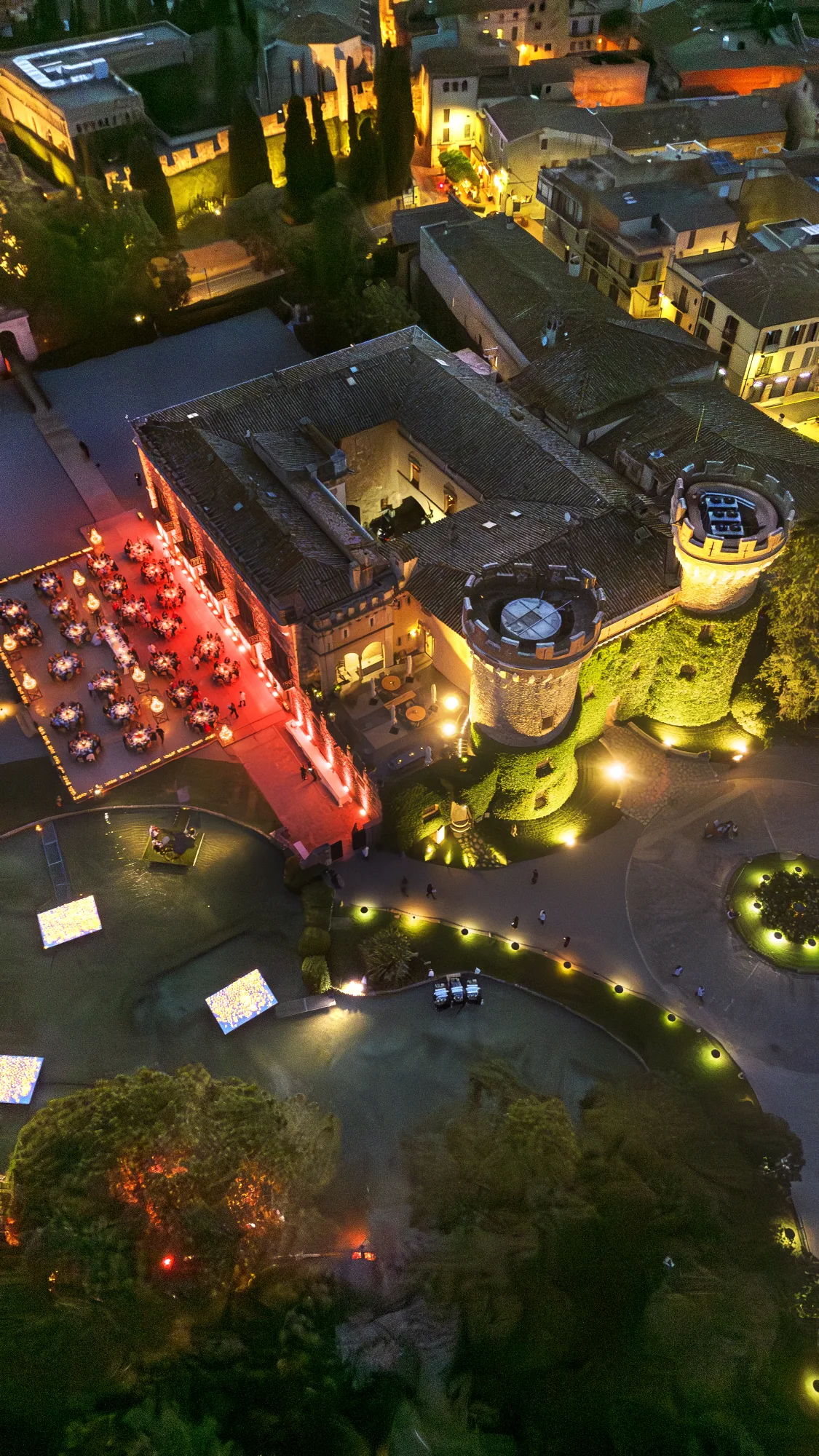 Aerial view of a villa lit for a night reception