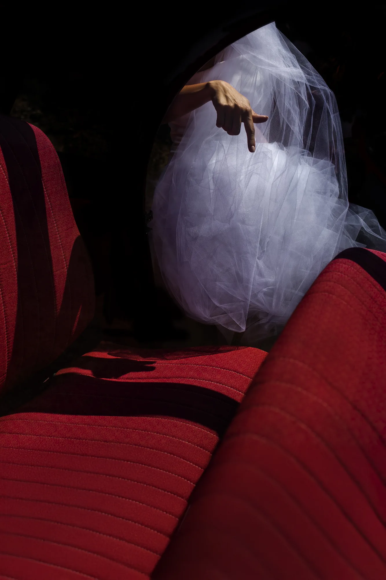 Bride's veil over red velvet seats