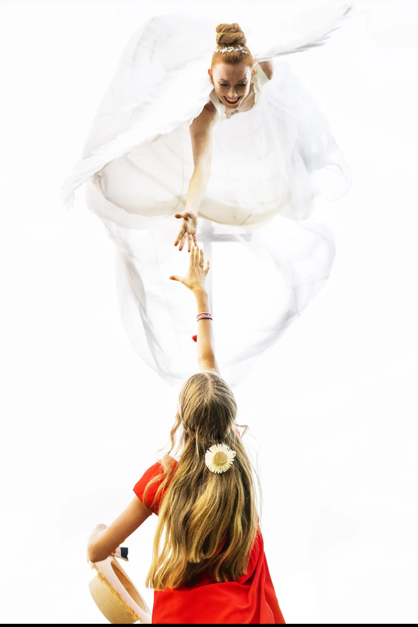 Bride seen from above as a girl in red looks up