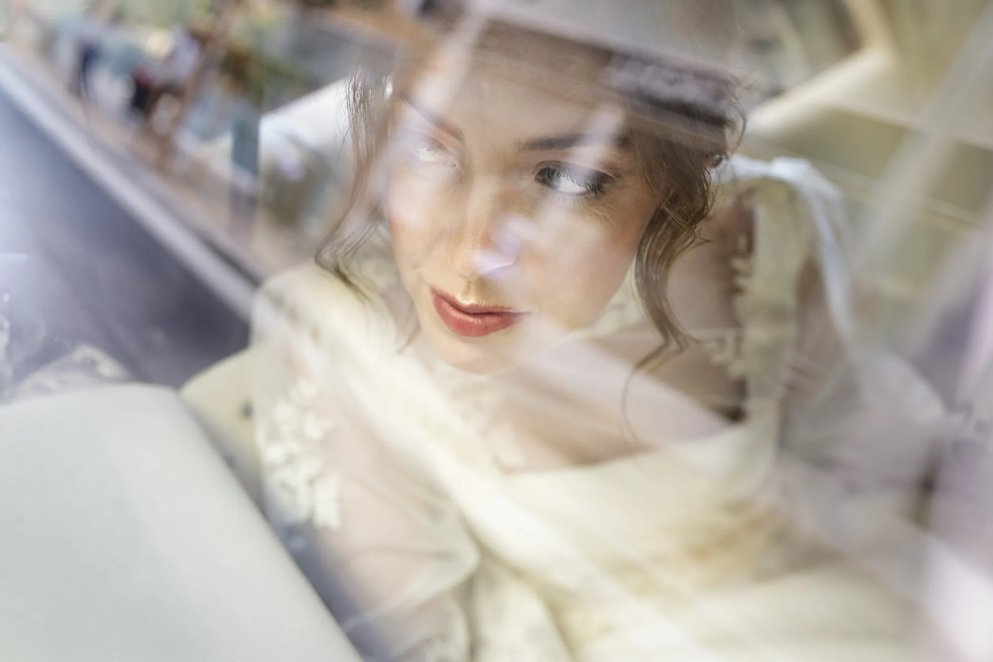 Bride seen through a window reflection