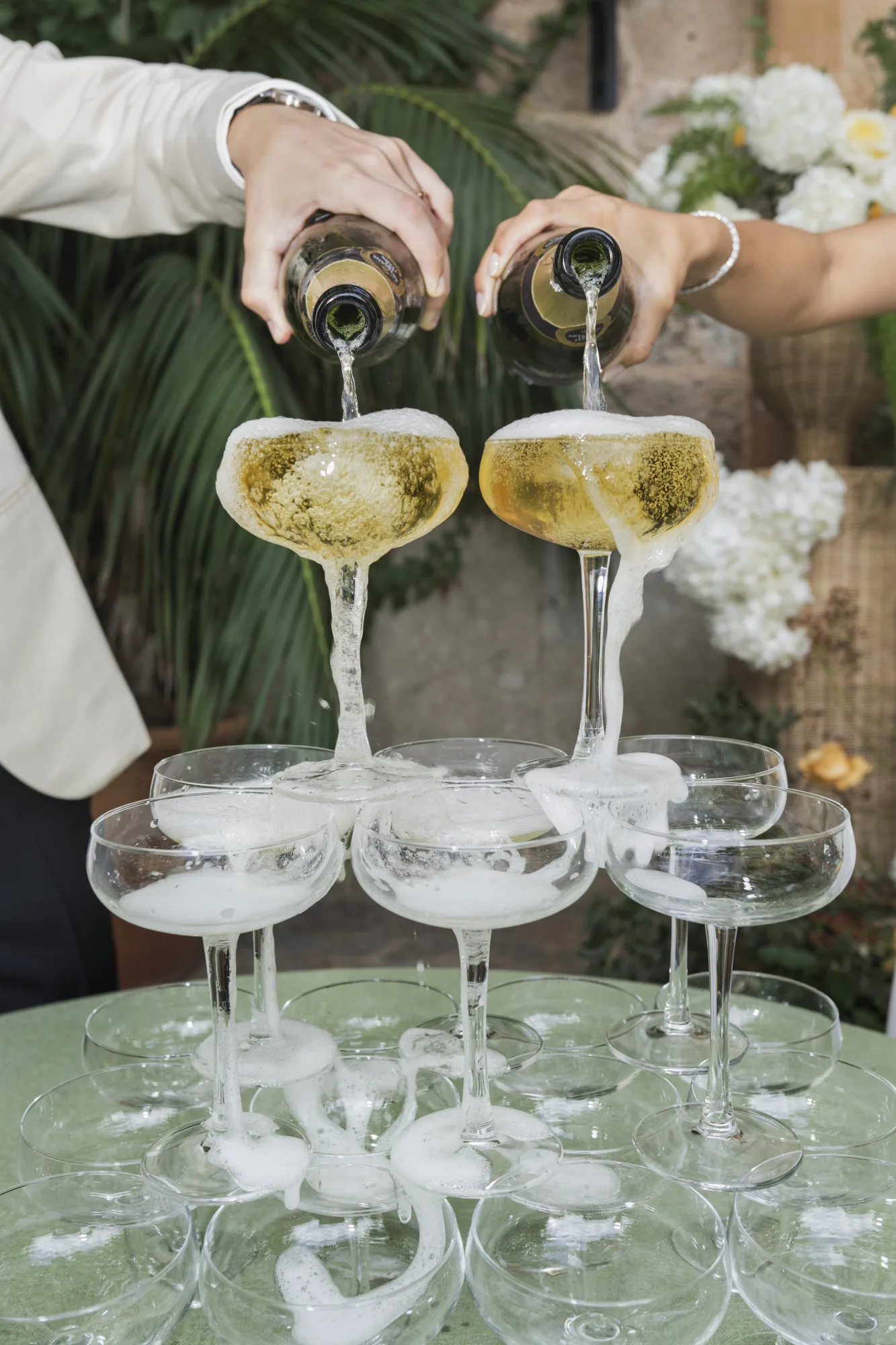 Champagne poured into a tower of coupes