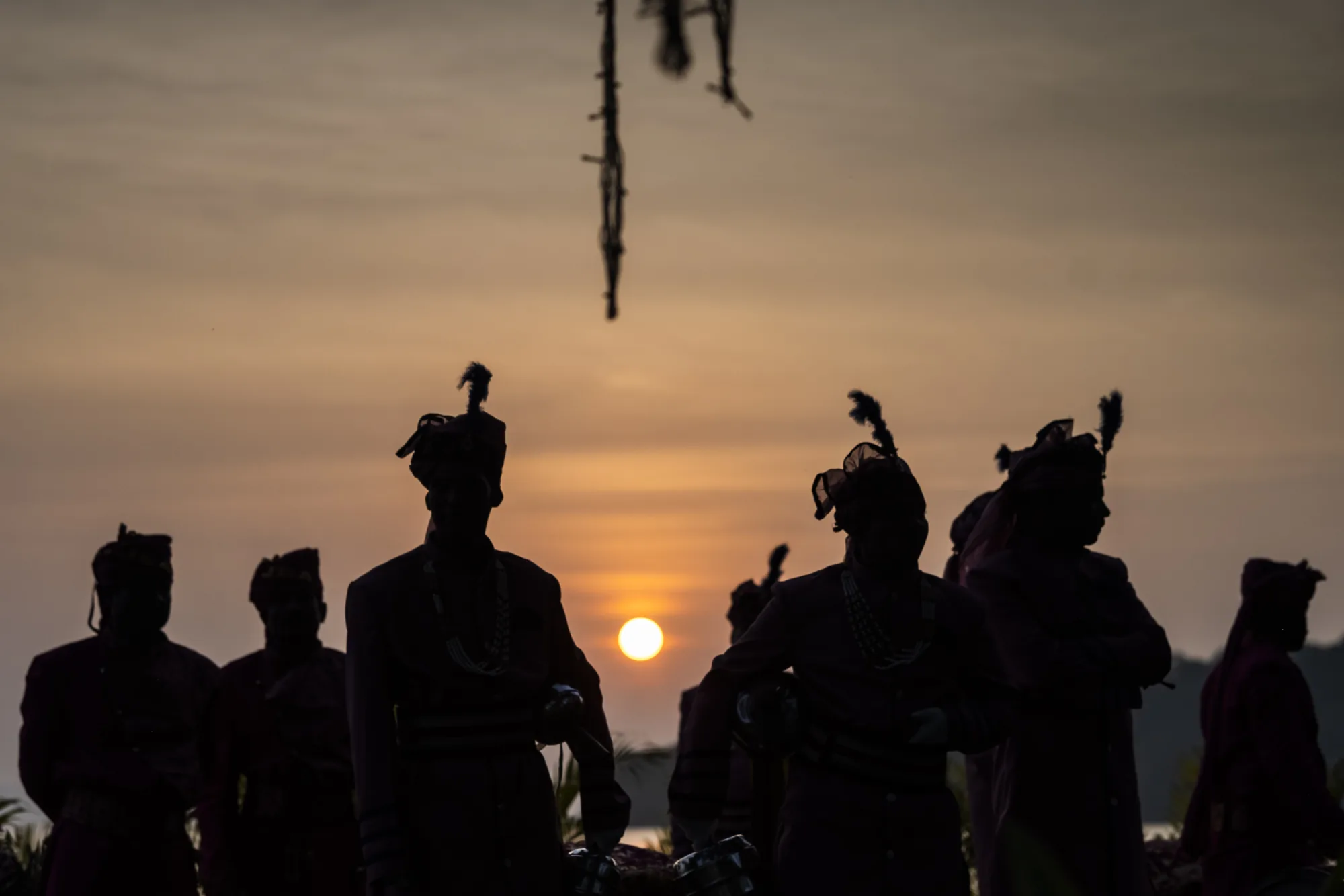 Guests silhouetted against the setting sun