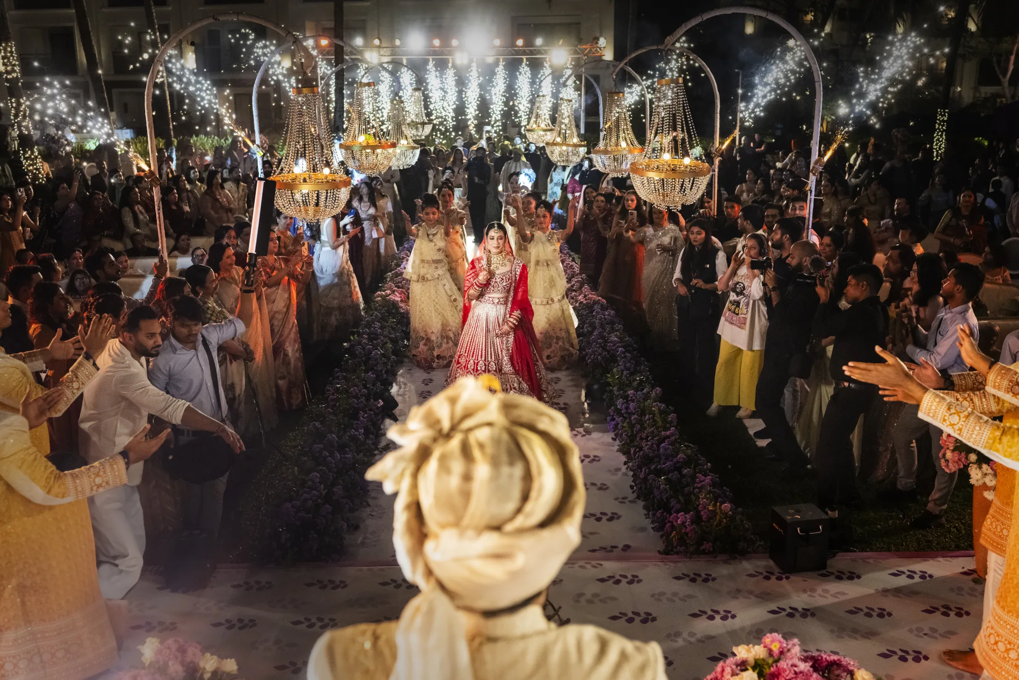 Indian wedding reception crowd beneath glittering lights